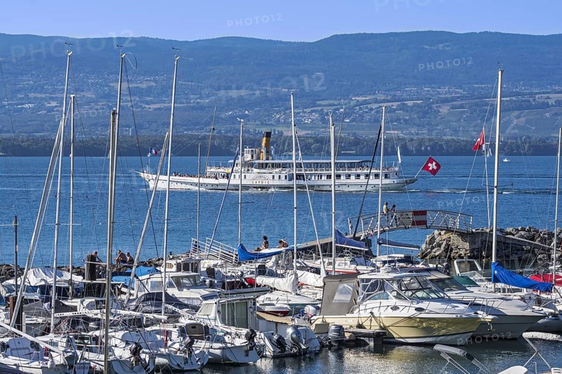 Swiss historic Belle Epoque paddle steamboat Savoie and sailing boats in the marina at Yvoire along Lake Geneva