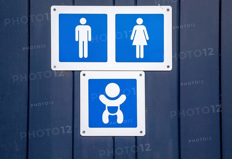 Male female unisex and baby changing signs on public toilets