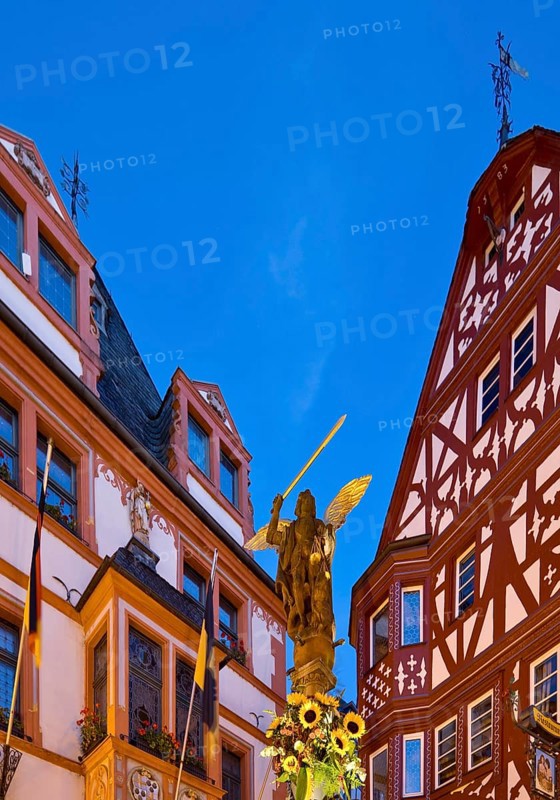 St. Michael's Fountain with town hall and gabled half-timbered house in the evening
