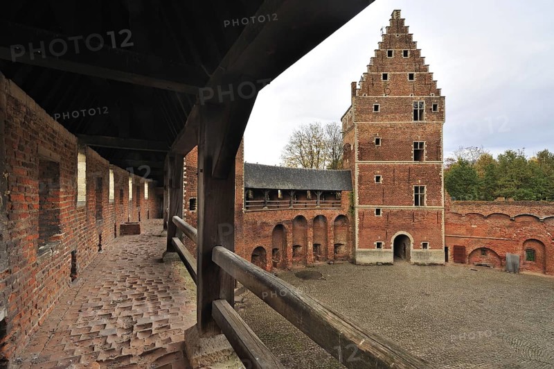 Worn-out red bricks in corridor and inner court of the medieval Beersel Castle