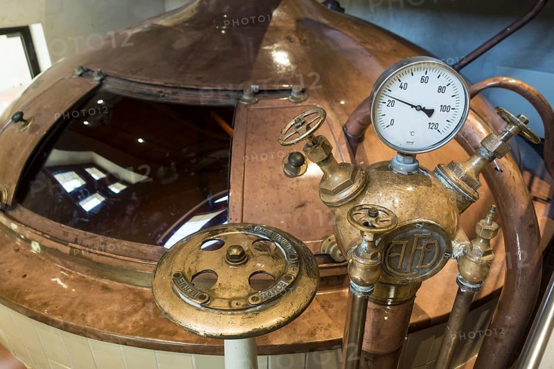 Gauge and valves on copper kettle of Trappist beer brewery in the Orval Abbey