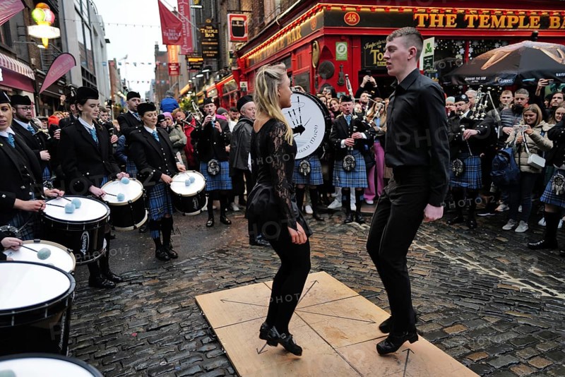 Dancers performing to music being played by the Clew Bay Pipe band in Temple Bar during Trad Fest. Temple Bar