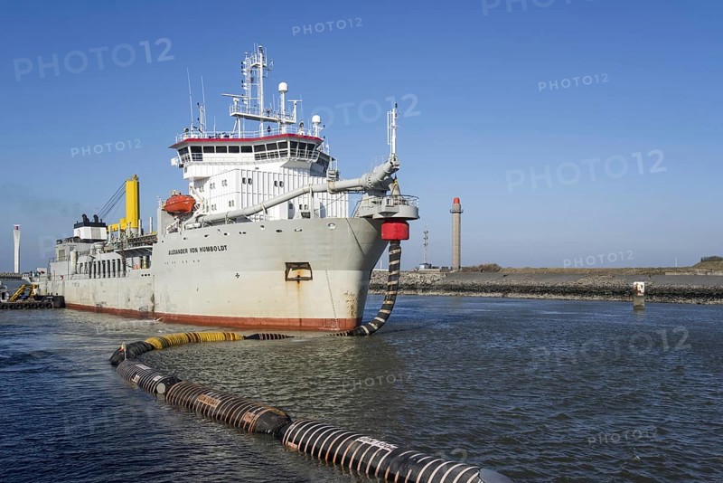 Trailing suction hopper dredger Alexander von Humboldt in port of Ostend discharging sand via long hoses