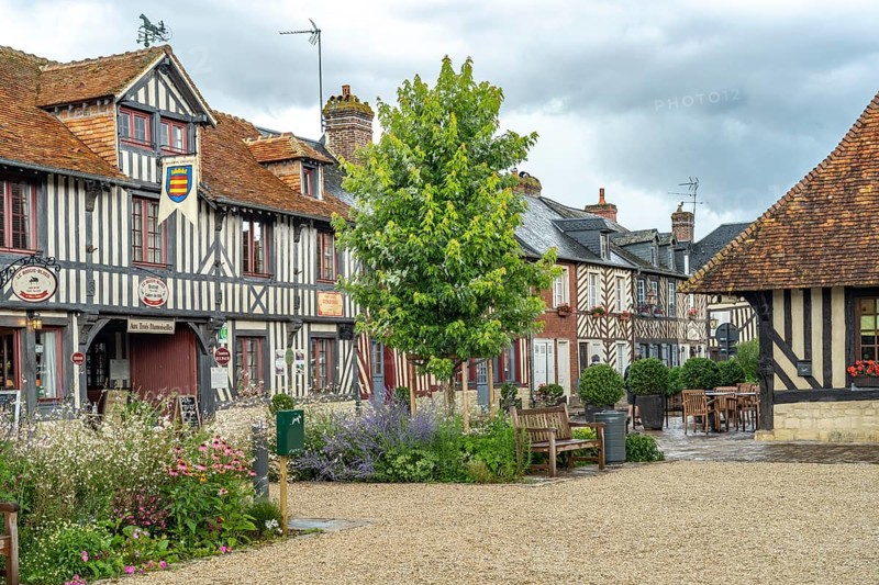 Half-timbered houses and cafes in one of the most beautiful villages in France Beuvron-en-Auge