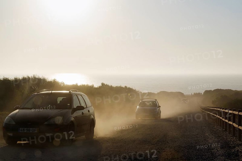 Cars driving on dusty track