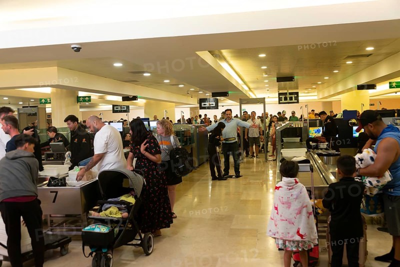 People passing through security check inside Cancun airport
