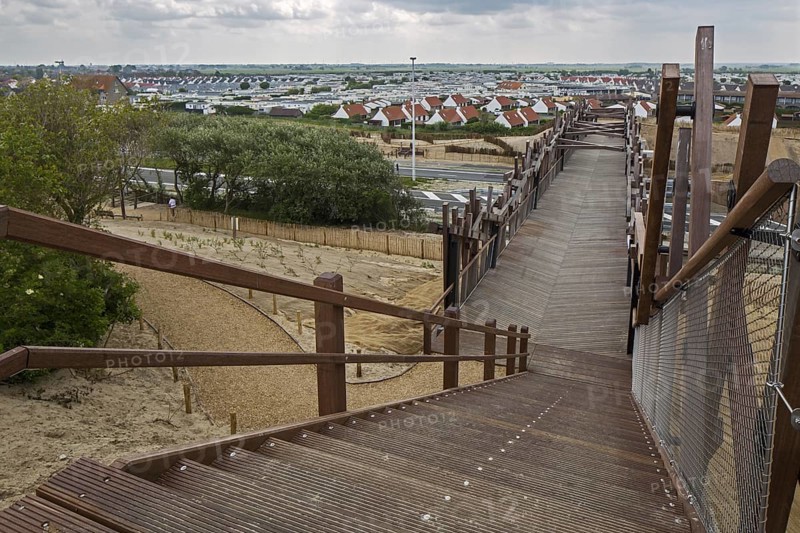 The wooden footbridge Het Wrakhout and holiday resort along the North Sea coast at Westende