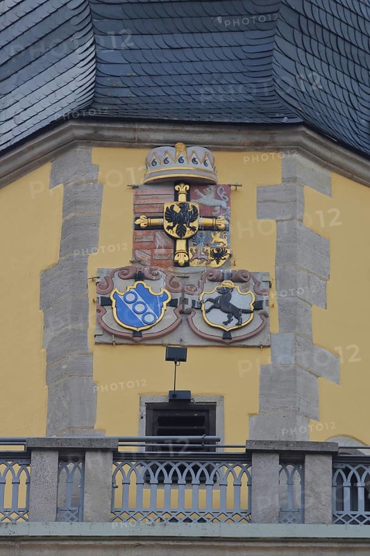 City coat of arms and parapet on the tower of St. John's Minster