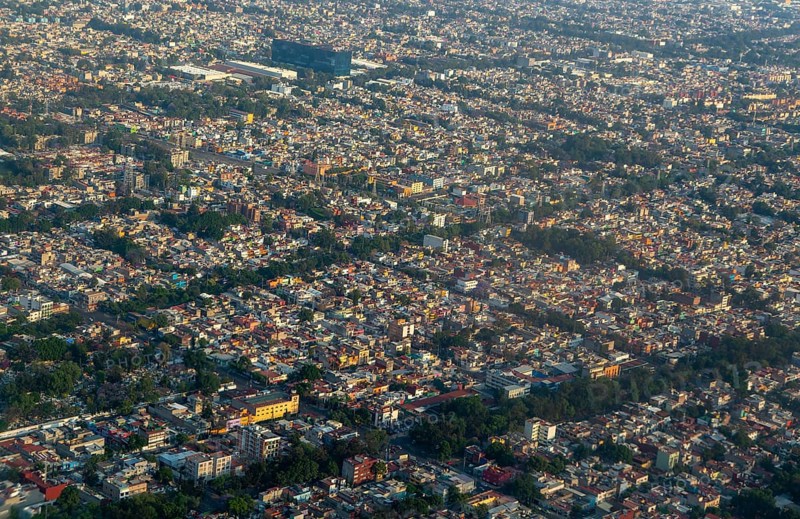 Oblique angle aerial view through plane window over Mexico City