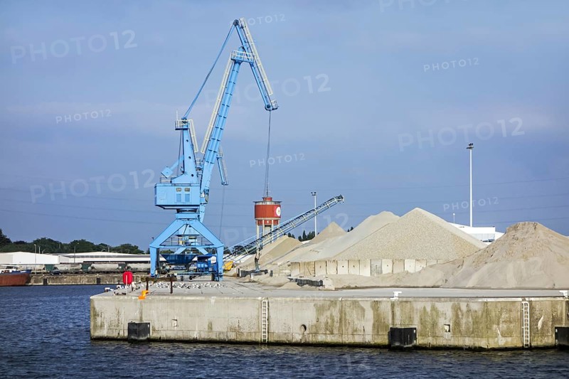 Dock crane and heaps of sand at the Ch. Kesteleyn gravel terminal in the port of Ghent