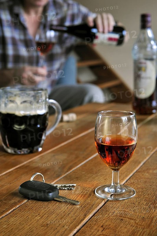 Car key and man pouring alcohol