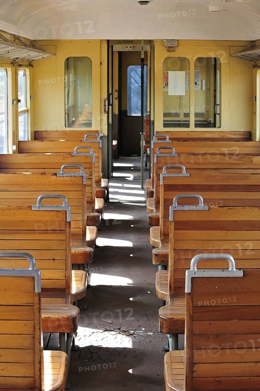 Old passenger carriage with wooden benches at the depot of the Chemin de Fer a Vapeur des Trois Vallees at Mariembourg