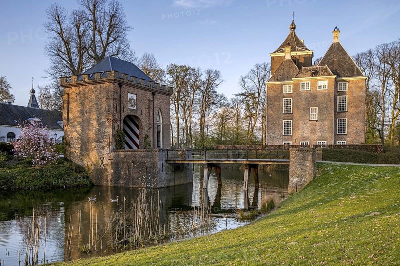 Medieval castle Soelen with gatehouse and bridge over moat at Buren in spring