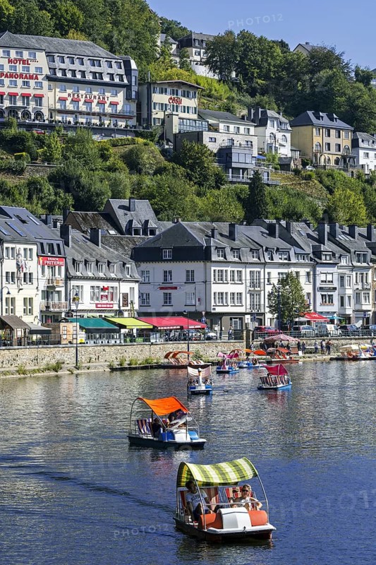 Paddle boats with tourists on the Semois river in the city Bouillon in summer