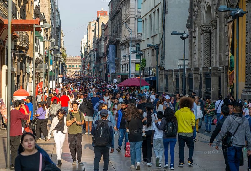 Crowd of people on pedestrianised street Avenida Madero