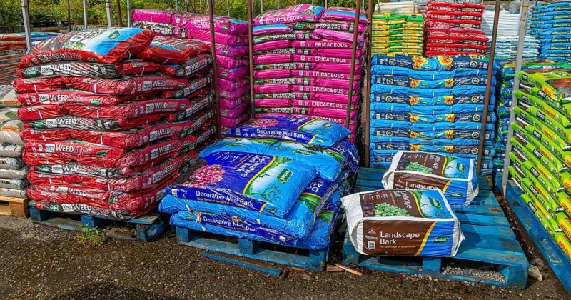 Bags of bark and compost on sale in garden centre