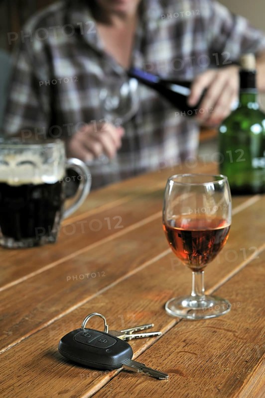 Car key and man pouring alcohol