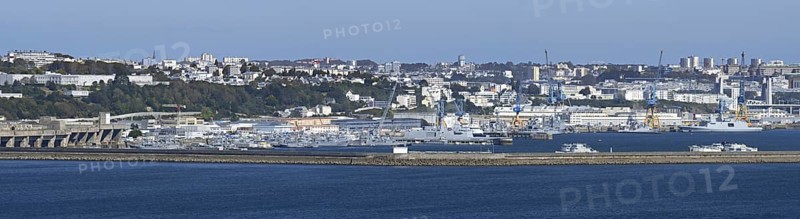 Panoramic view over German WW2 U-boat submarine pen and French Navy ships docked in the port