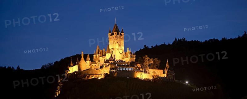 Illuminated Reichsburg Cochem in the evening