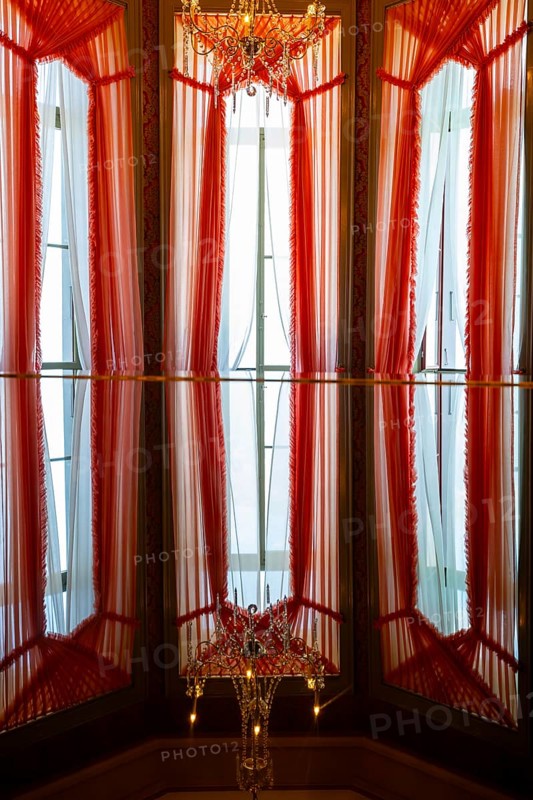 Beautiful Windows with Curtains and Crystal Lamp and Reflection in Switzerland
