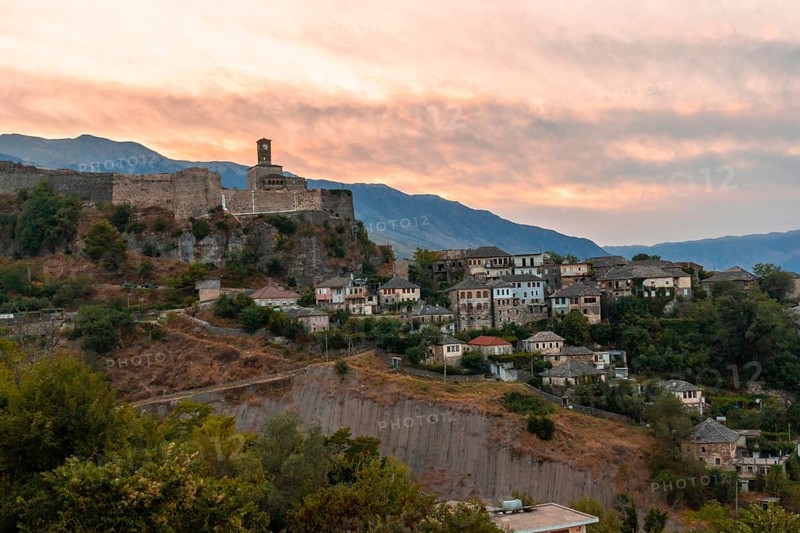 Sunset over the clock tower and fortress of Gjirokaster