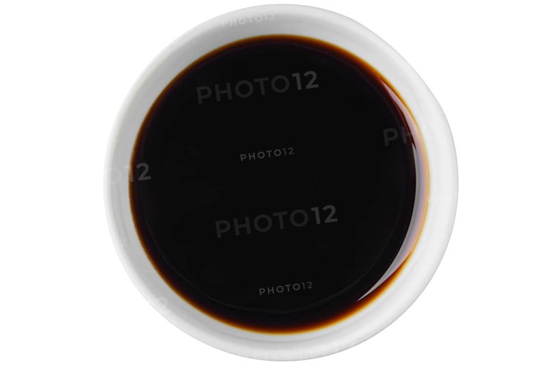 Top view of bowl with oyster sauce isolated on white background