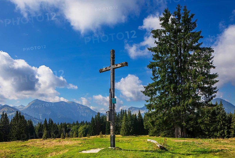 Summit cross on the Breitenberg with a view of the Osterhorn