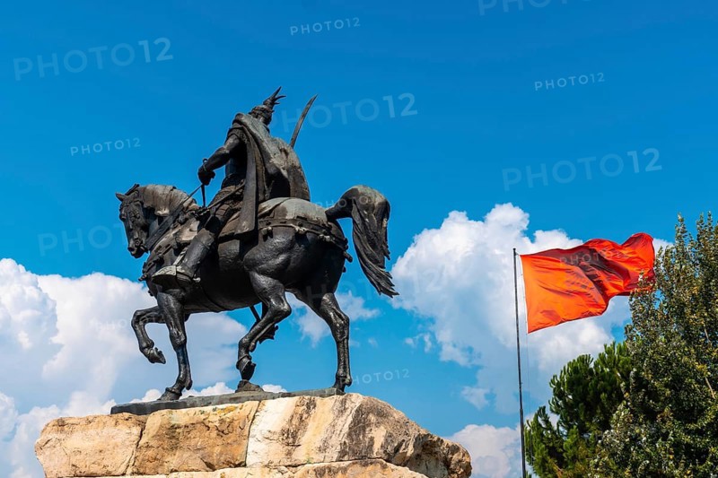 Skanderbeg horse monument at Skanderbeg Square in Tirana and the red flag of Albania