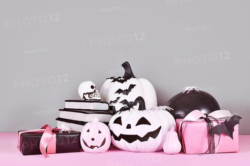Pink and white Halloween decor with black and white pumpkins