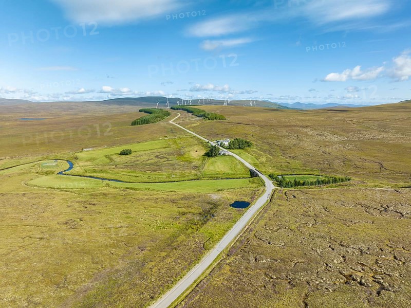 Aerial view of the single track road A836 between Lairg and Altnaharra with the remote hotel The Crask Inn