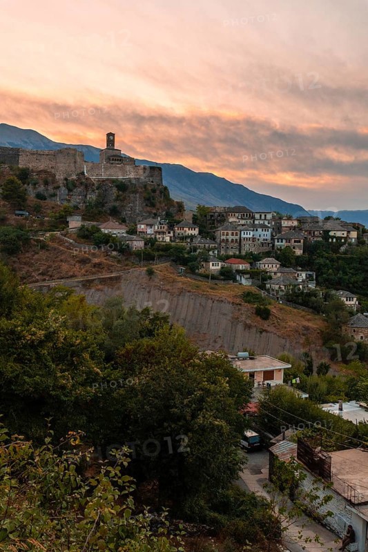 Sunset over the clock tower and fortress of Gjirokaster