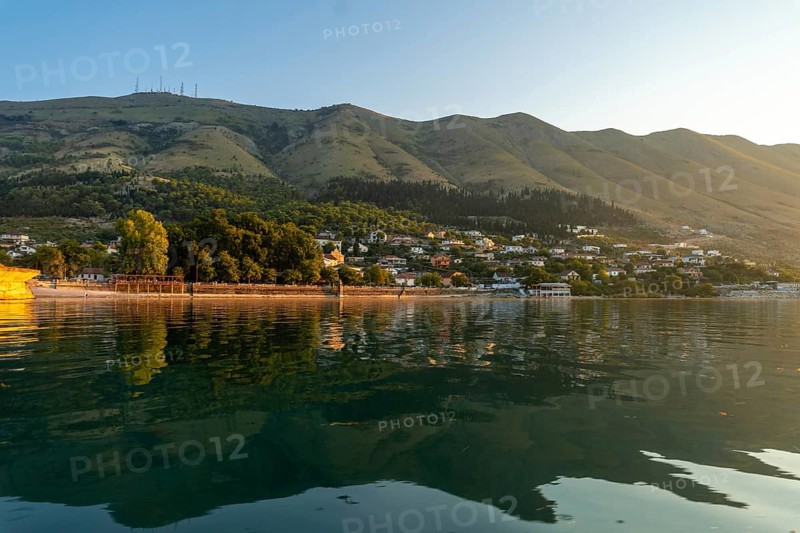 View of the city of Shiroka from the lake on a traditional boat on a sightseeing excursion from Shkoder. Albania