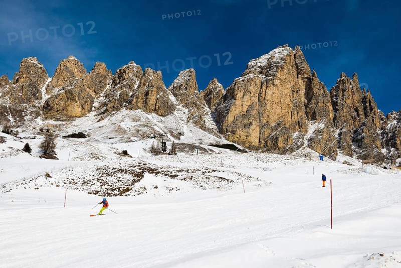 Snow-covered mountains and skiers