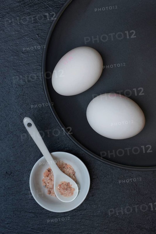 Two eggs and shell with natural salt