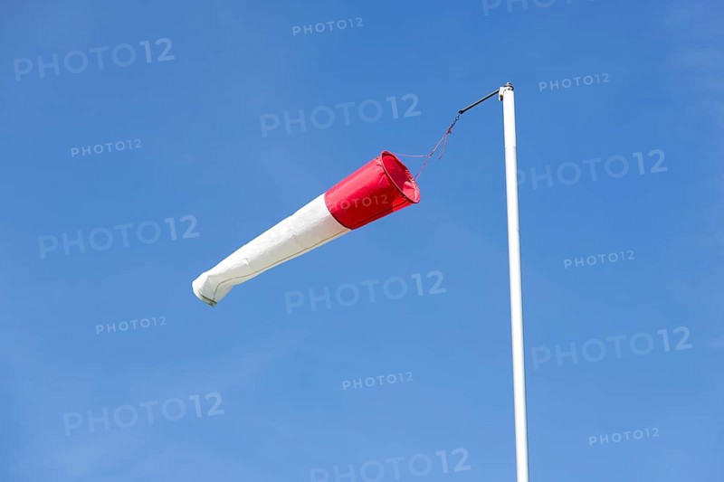 White-red windsock against blue sky