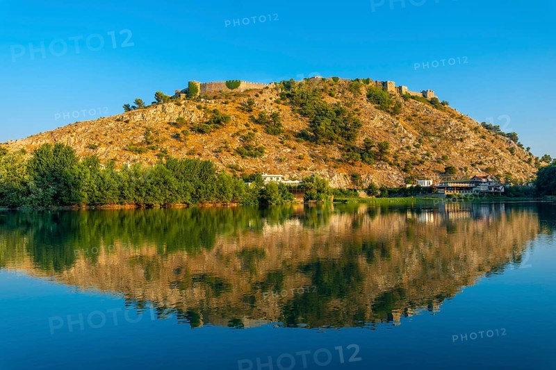 View of Rozafa Castle from a boat on a sightseeing excursion on Lake Shkoder in Shiroka. Albania