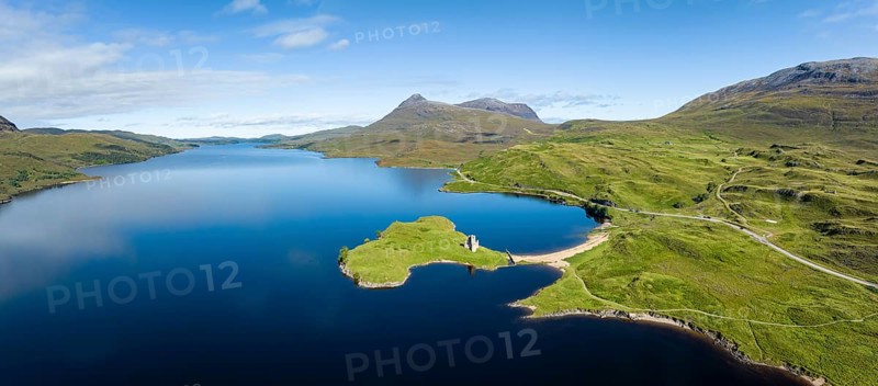 Aerial panorama of the freshwater loch Loch Assynt with the ruins of Ardvreck Castle on a peninsula