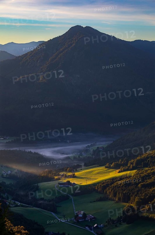 Farms at sunrise and morning fog near Ebenau