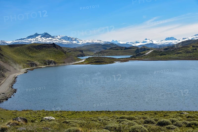 Gravel road in Torres del Paine National Park with snow-capped mountains