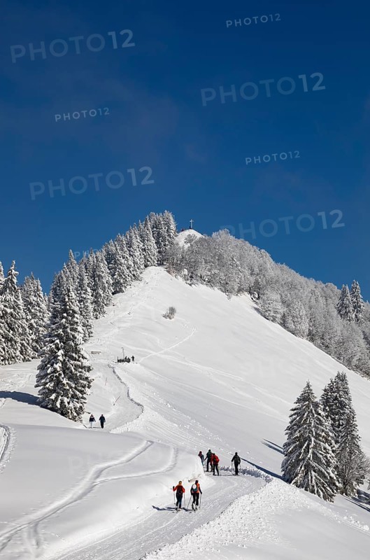 Deep snowy winter landscape with ski tourers on the way to the Zwoelferhorn