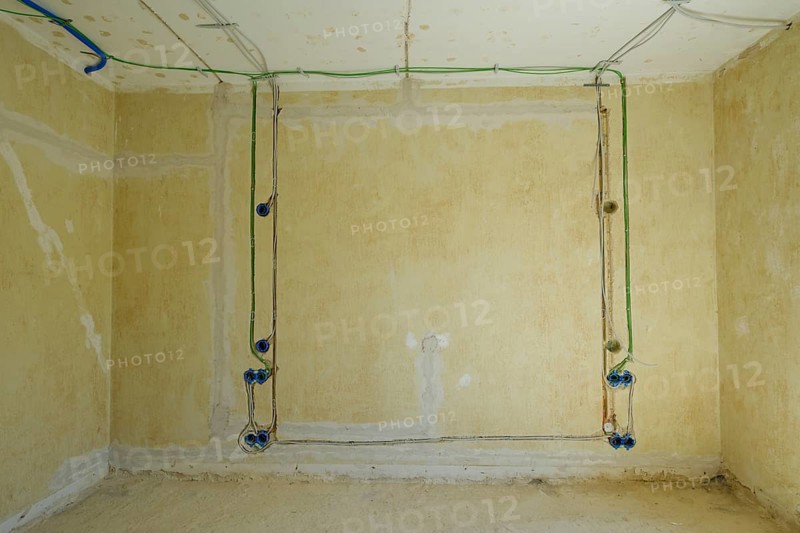 Power and network cables on a wall