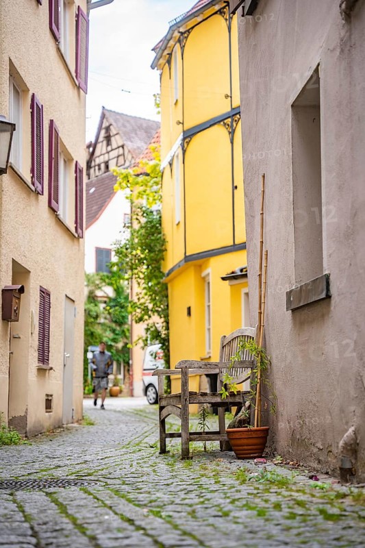 Narrow alleyway alley with wooden bench