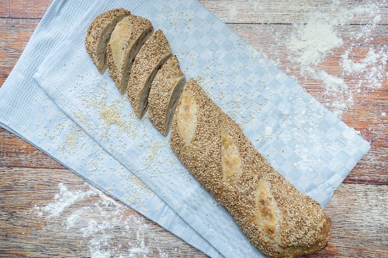 Freshly baked vegan baguette with sesame seeds