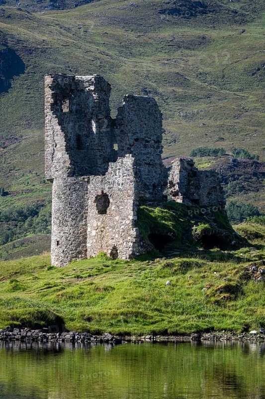 The ruins of Ardvreck Castle on a peninsula in the freshwater loch of Loch Assynt