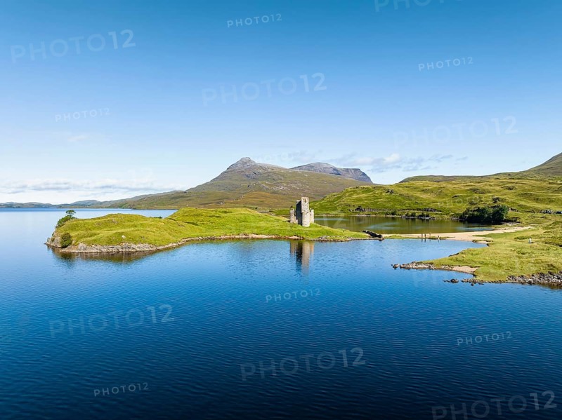 Aerial view of the freshwater loch Loch Assynt with the ruins of Ardvreck Castle on a peninsula