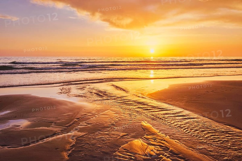 Atlantic ocean sunset with surging waves at Fonte da Telha beach