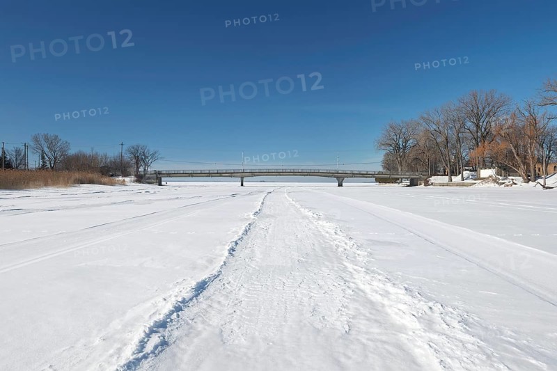 Vehicle tracks on snow covered frozen river