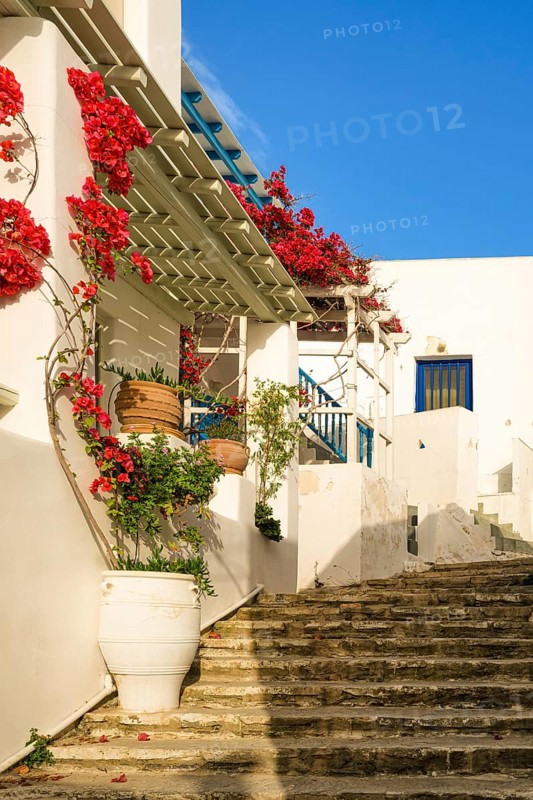 Traditional Greek island town alleyway with whitewashed walls