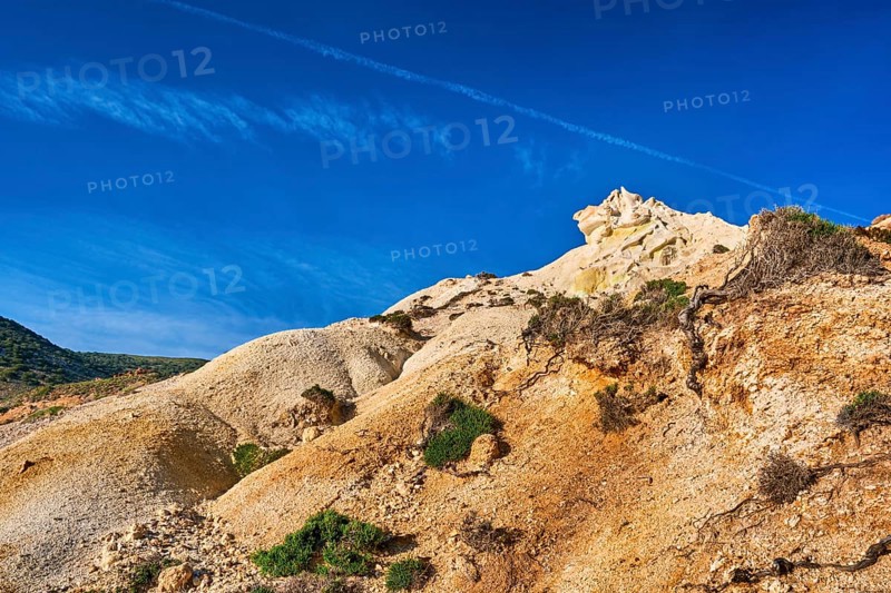 Unique natural rock formations of yellow and orange cliffs in low sunlight