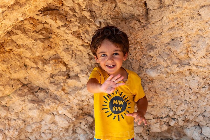 Boy having fun on Porto Katsiki beach in Lefkada island on vacation